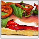 Italian paninis with mozarella cheese, peppers, basil and dried ham